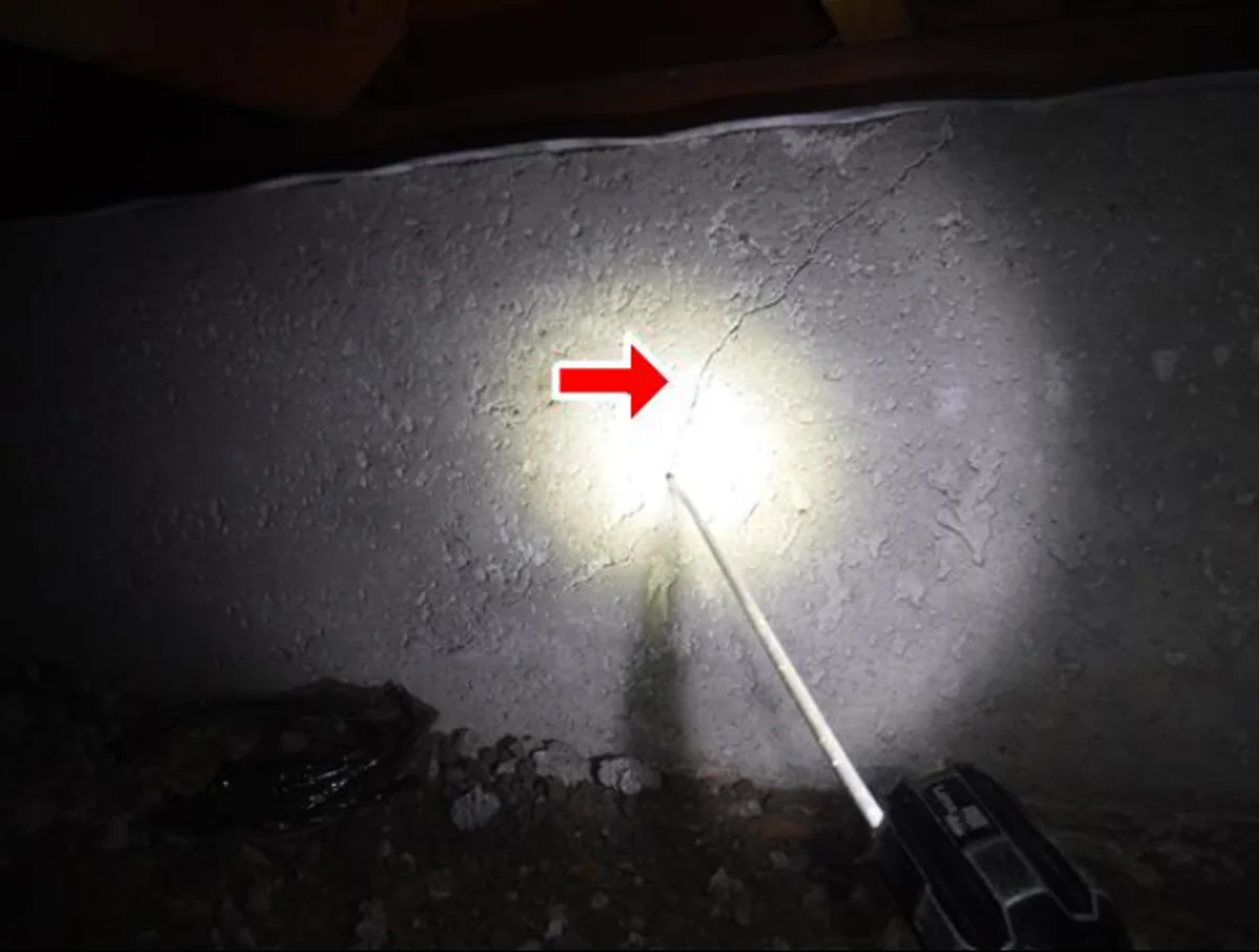 Crack in a crawl-space foundation wall located during a flashlight inspection