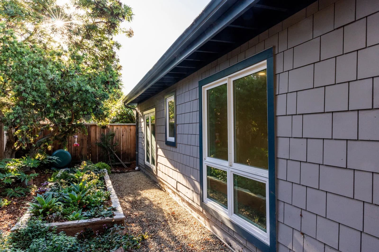 Detached backyard dwelling beside mature trees and landscaped open space