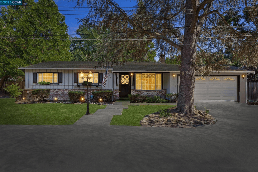 Existing house at dusk showing planned shared driveway access for fire department