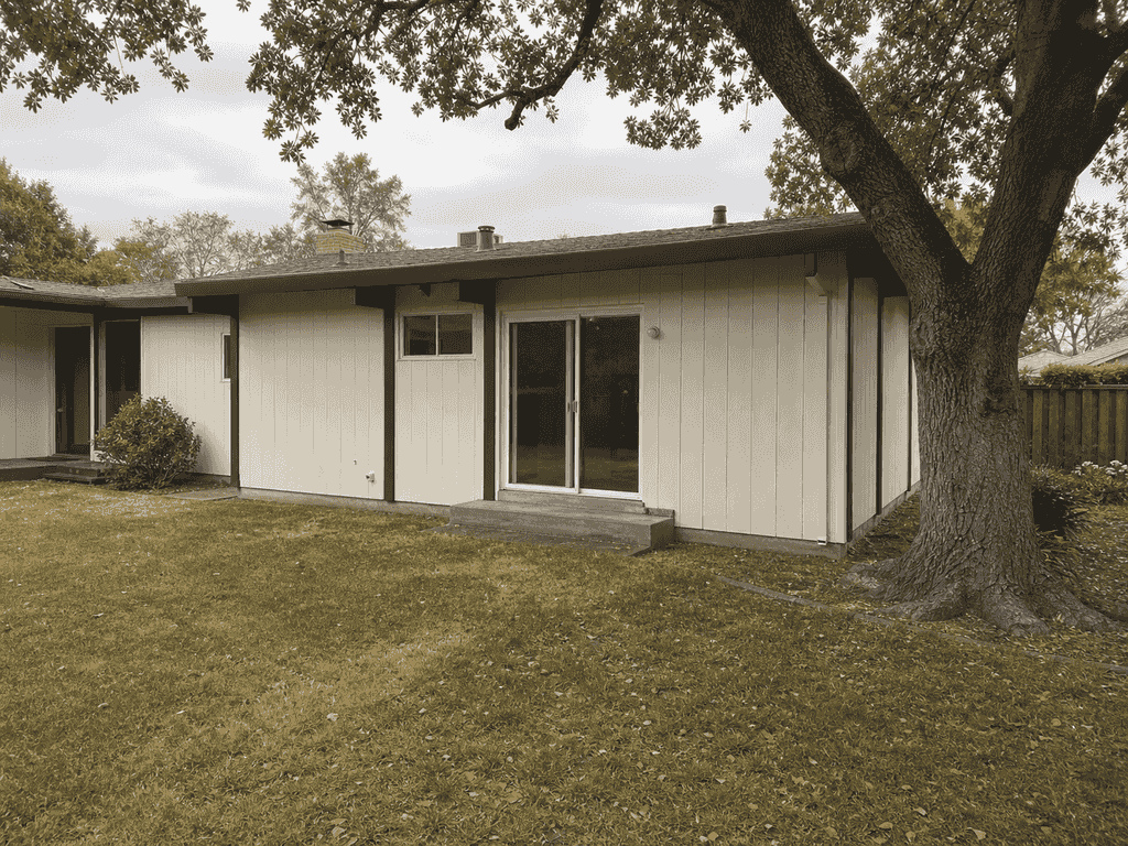 Rear of the mid-century Palo Alto home before the addition, with the protected oak nearby