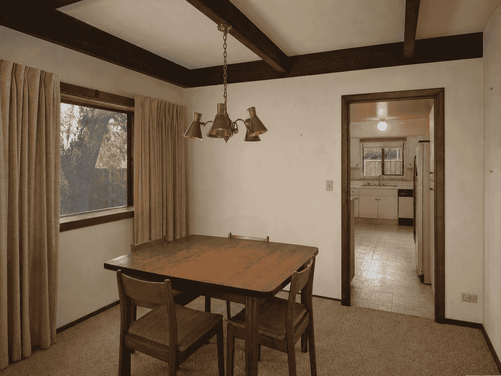 Closed-off dining room with limited garden connection before the remodel