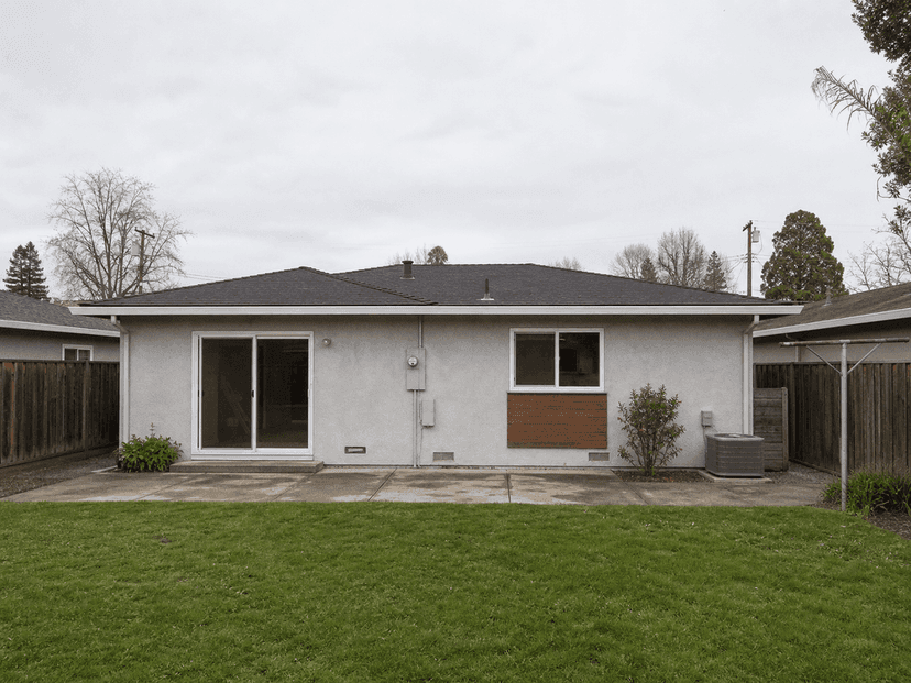 Rear yard view showing original low roofline before the second story was added