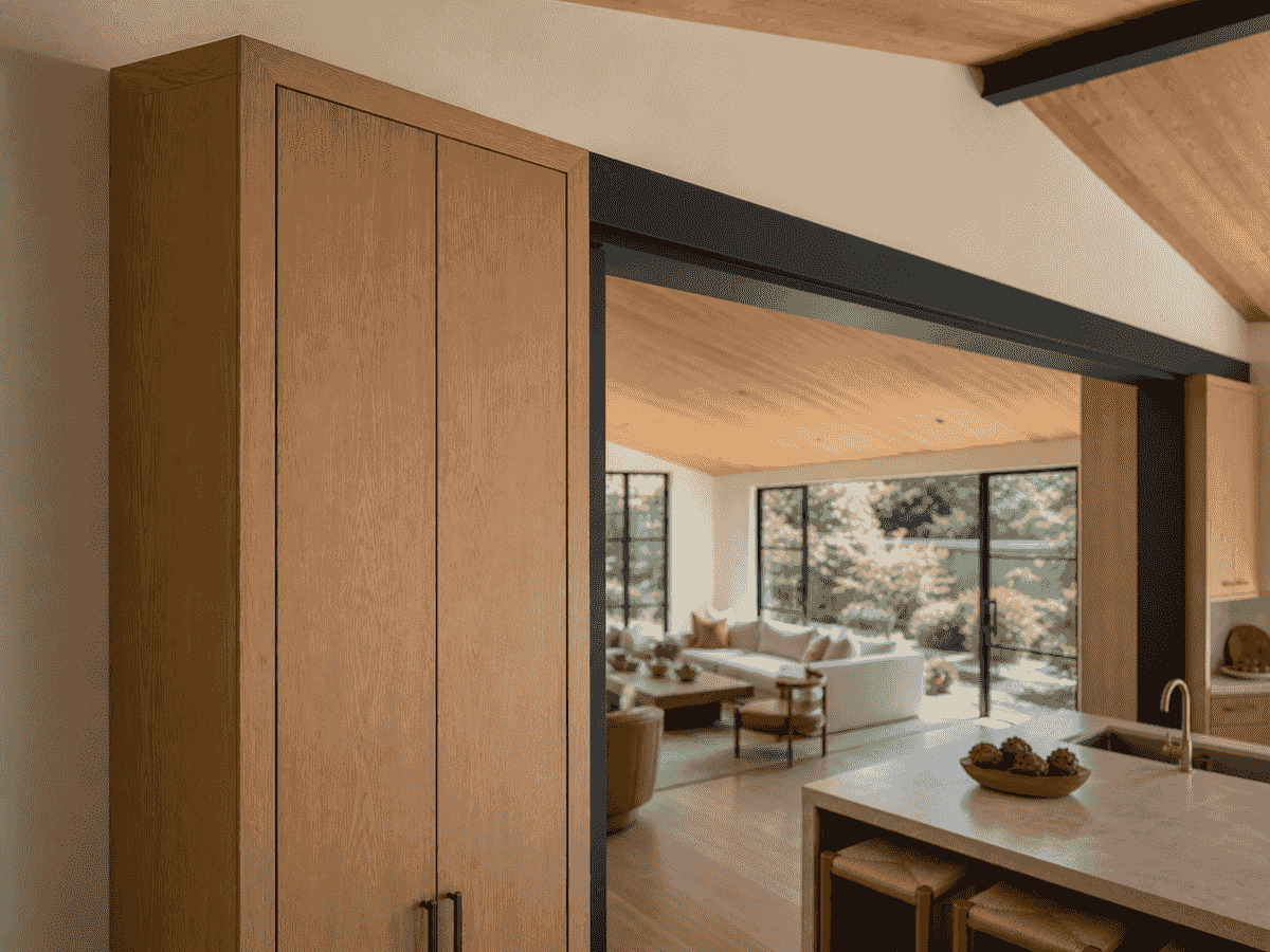 Moment-frame column integrated into a white oak cabinet pier